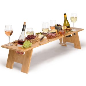 lungo-tavolo-table-lifestyle The Catalogue Lungo Tavolo Table is a foldable bamboo table. Alfresco style with holders for bottles and glasses.